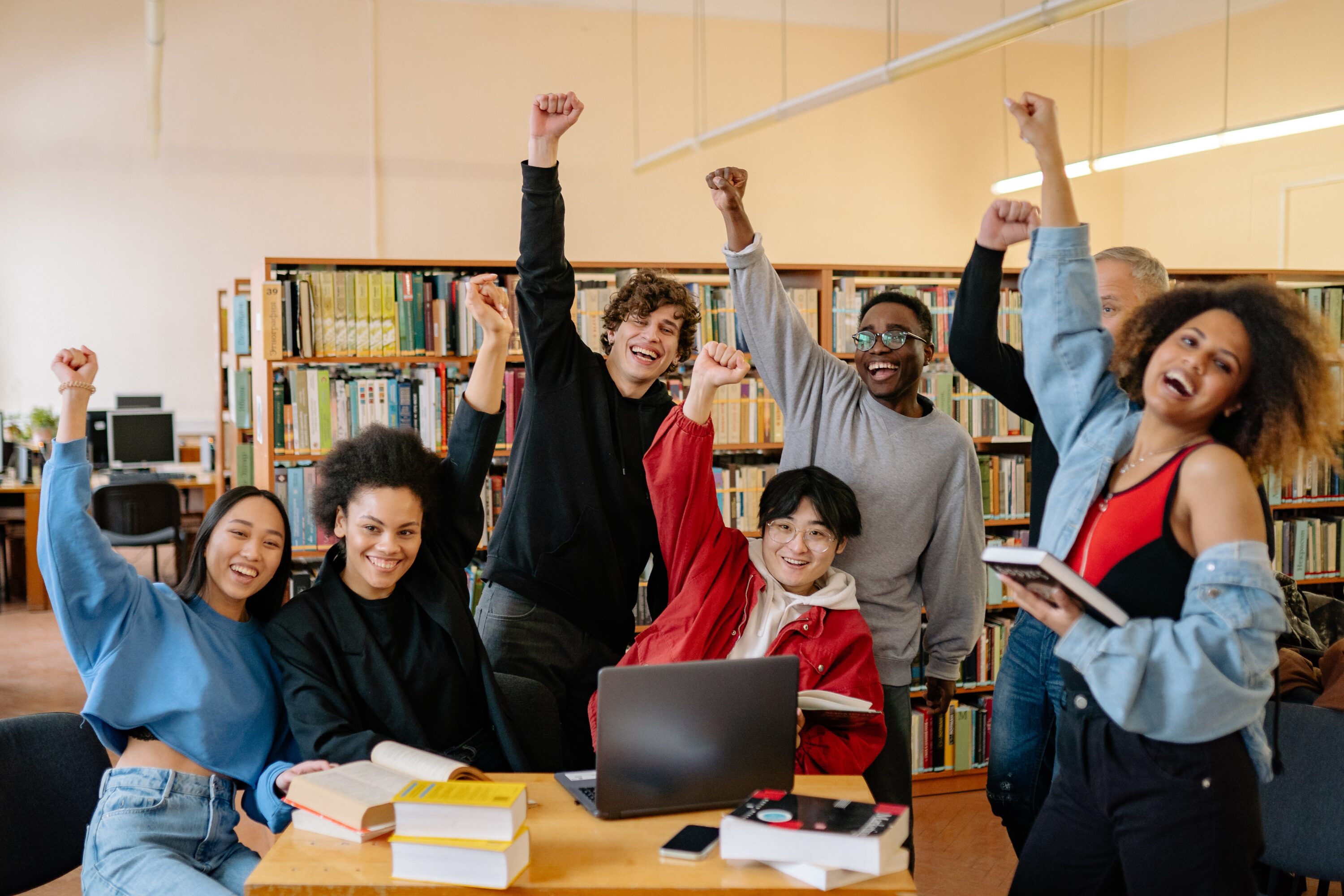 teens celebrating by raising fists in the air